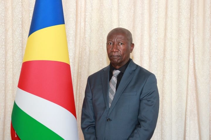 The Office of the President has today announced the appointment of Dr Bernard Valentin as Chairperson of the University of Seychelles Council, effective 24th March 2026, for a period of three (3) years. Dr Valentin brings to this role a distinguished record of public health leadership and national service. He currently serves as Special Advisor to the Minister for Health and has over a decade of experience as Principal Secretary for Health, having held the position across two terms from 2011 to 2012 and from 2016 to 2025. During his tenure, he provided executive oversight to the National Institute of Health and Social Studies, contributing significantly to the strengthening of academic programmes and institutional development. His leadership experience spans multiple national bodies. Dr Valentin is currently Chairperson of the Seychelles Medical and Dental Council and also chairs the non-governmental organisation Patient Solidarity. Since 2018, he has served as a member of the Seychelles Qualifications Authority and previously sat on the University of Seychelles Council between 2016 and 2018. At the international level, he represented Seychelles on the Executive Board of the World Health Organisation for three years, reflecting his engagement in global health governance. Dr Valentin holds a medical degree from the University of Athens and a Master of Arts in Health Services Management with distinction from the University of Manchester. He also holds a combined diploma in Epidemiology, Statistics and Management from the University of Nairobi, as well as a Diploma in Addiction Studies from the University of Reunion. In addition to his professional accomplishments, Dr Valentin has contributed to academic research, including coordinating the Seychelles component of an international study in collaboration with Lund University and the University of Rochester on the long-term public health effects of heavy metals on specific population groups. He has also co-authored a peer-reviewed article in the field of public health. Beyond his medical and policy career, Dr Valentin is an accomplished literary figure and a two-time laureate of the Antoine Abel Prize, Seychelles’ highest literary honour. Fluent in English, French, Greek, and Creole, he brings a unique combination of clinical expertise, administrative leadership, and cultural depth to the role. The Government welcomes Dr Valentin’s appointment and is confident that his extensive experience and leadership will contribute to the continued growth and strengthening of the University of Seychelles as a centre of academic excellence.